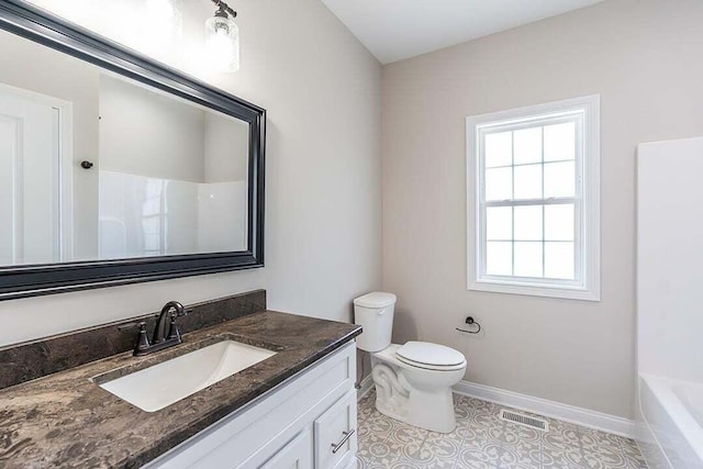 bathroom with tile patterned floors, vanity, and toilet