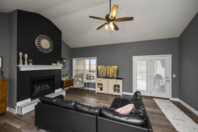 living room with lofted ceiling, hardwood / wood-style flooring, and ceiling fan