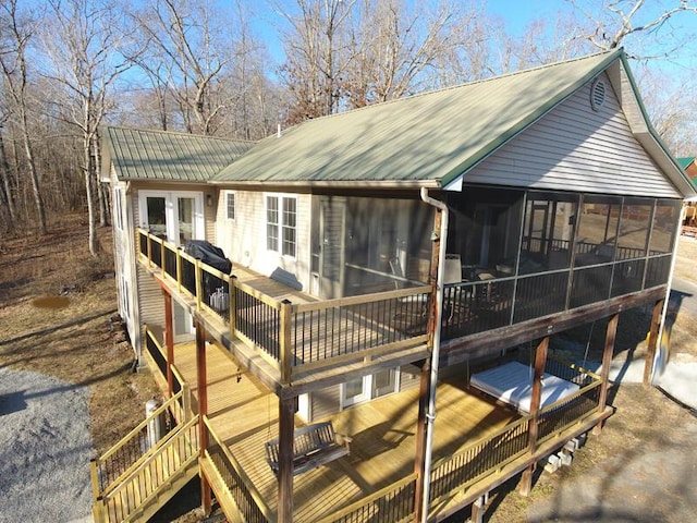 rear view of property with a sunroom