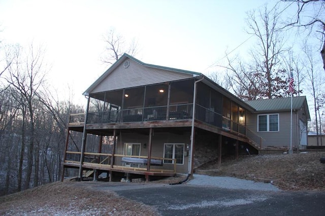 rear view of property with a sunroom