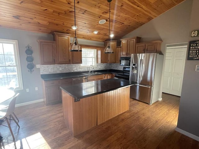 kitchen featuring sink, hanging light fixtures, light hardwood / wood-style floors, black appliances, and a kitchen island