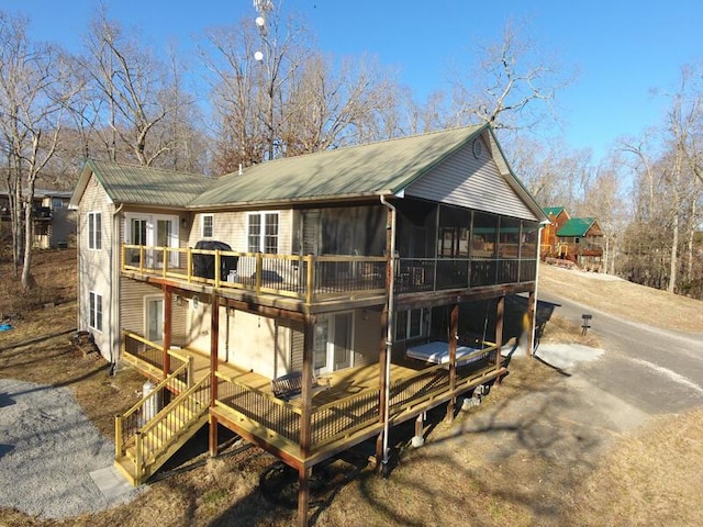 view of outbuilding with a sunroom