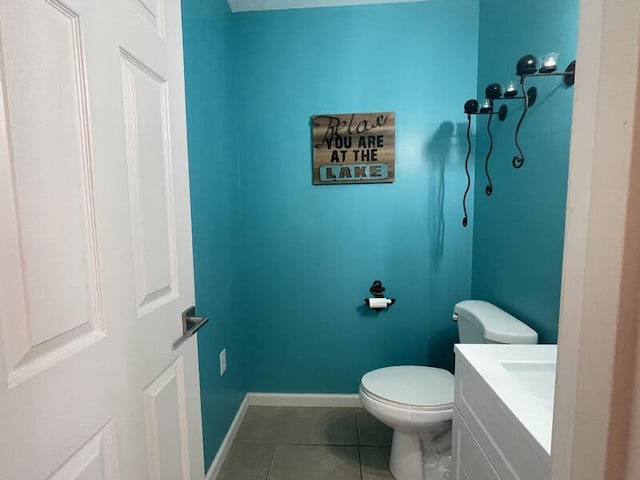 bathroom featuring tile patterned floors, toilet, and vanity