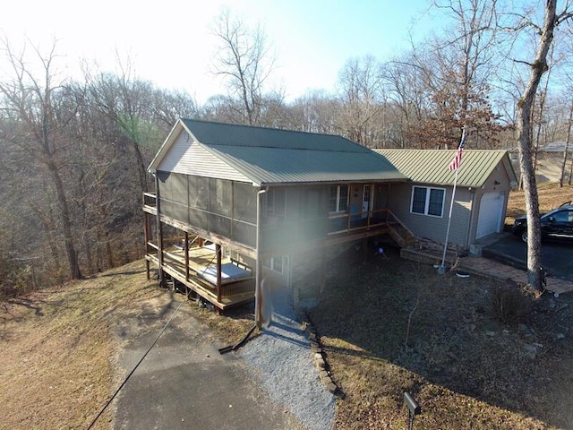 view of front of house with a garage and a sunroom