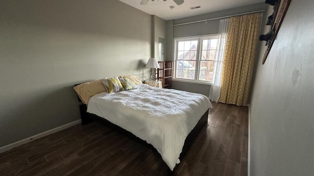 bedroom with ceiling fan and dark hardwood / wood-style floors