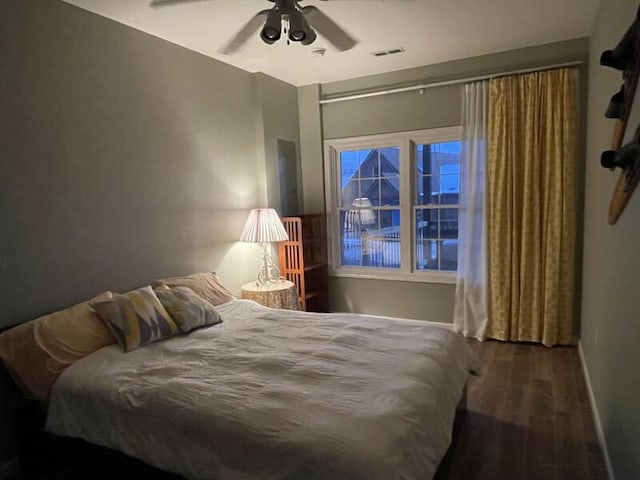 bedroom with ceiling fan and wood-type flooring