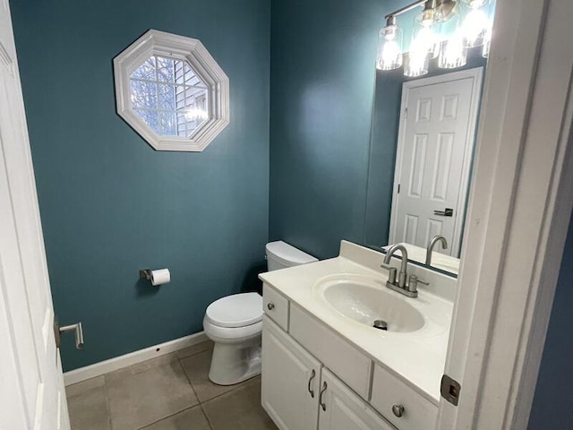 bathroom featuring vanity, tile patterned flooring, and toilet