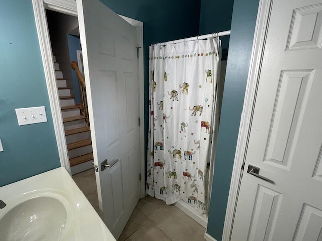 bathroom featuring tile patterned flooring, sink, and curtained shower