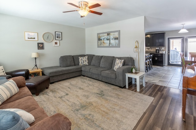 living room featuring dark hardwood / wood-style flooring and ceiling fan