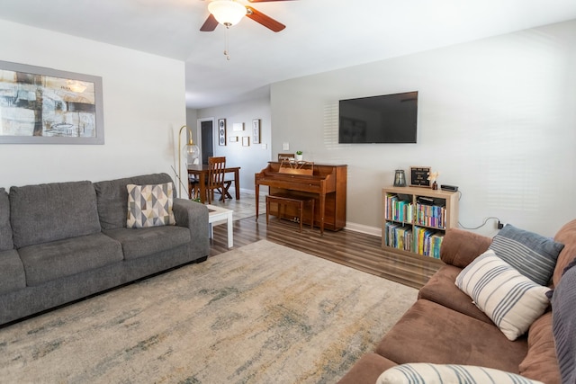 living room with ceiling fan and dark hardwood / wood-style floors