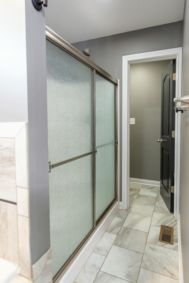 bathroom with a shower with shower door