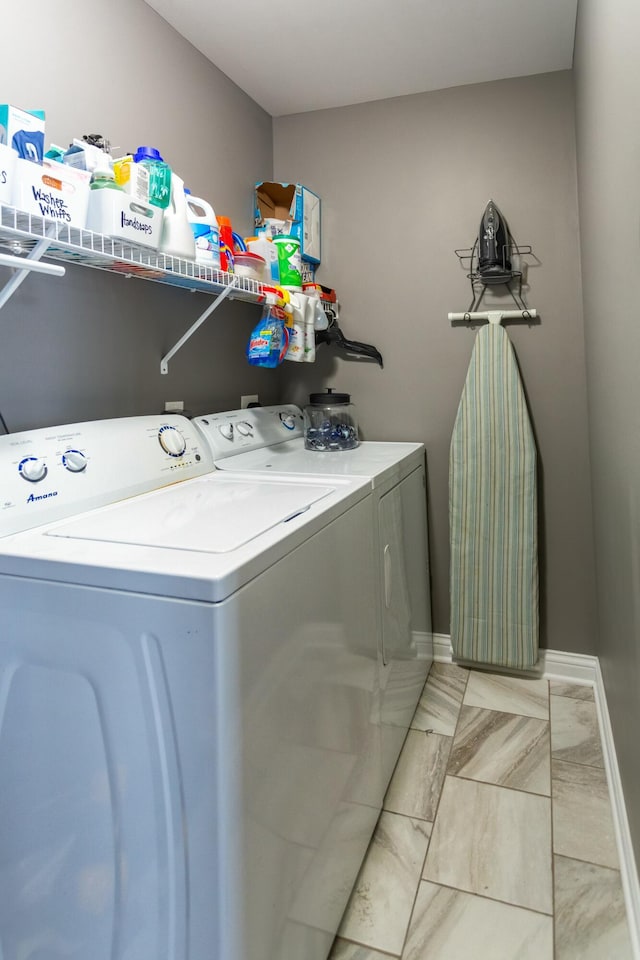 washroom with washing machine and clothes dryer and light tile patterned flooring