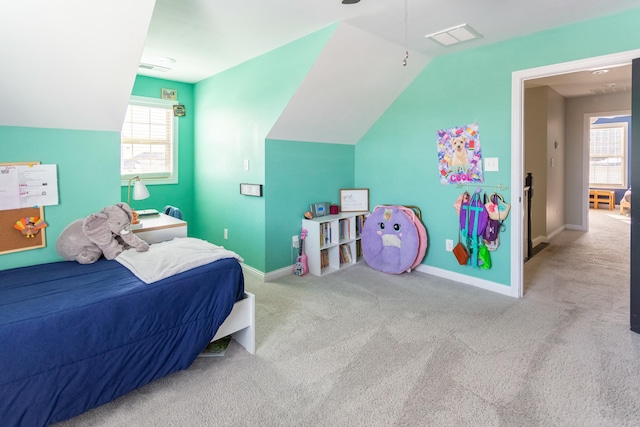 carpeted bedroom with vaulted ceiling