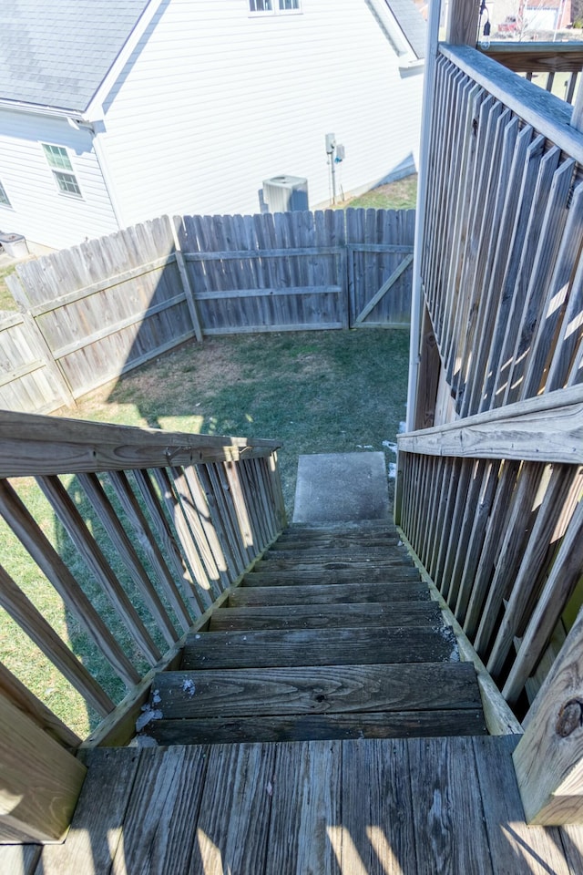 wooden terrace featuring a lawn