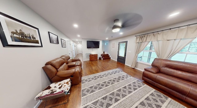 living room featuring hardwood / wood-style flooring and ceiling fan