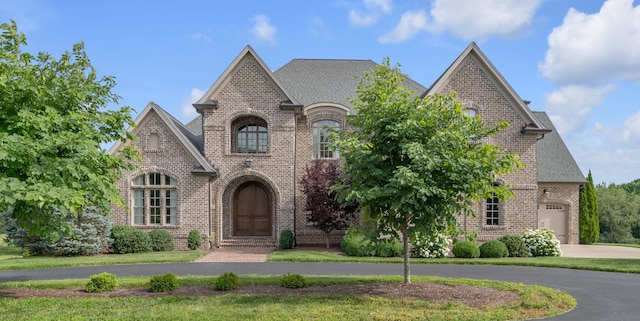 french country inspired facade with a garage