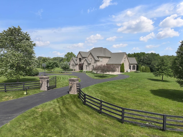 french provincial home with a front yard and a rural view