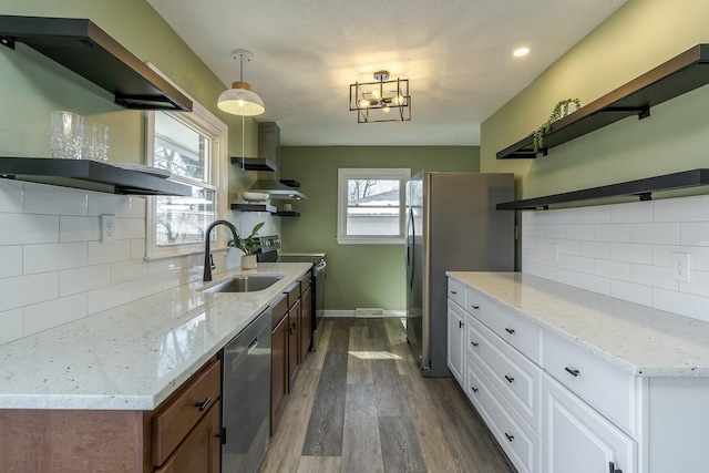 kitchen featuring sink, dark hardwood / wood-style floors, white cabinets, stainless steel appliances, and backsplash