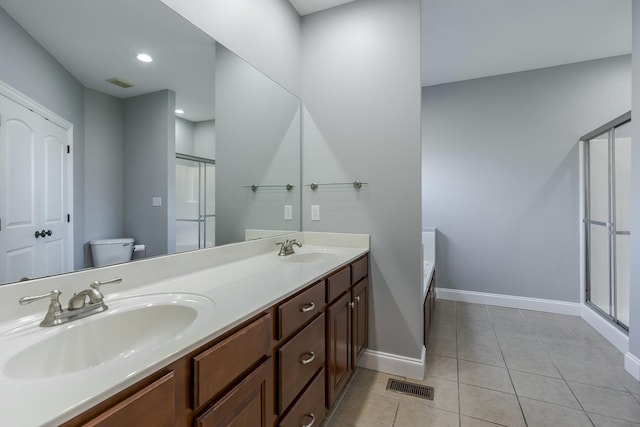 full bathroom featuring toilet, vanity, separate shower and tub, and tile patterned flooring