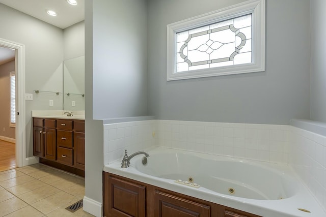 bathroom featuring a bathing tub, tile patterned floors, and vanity