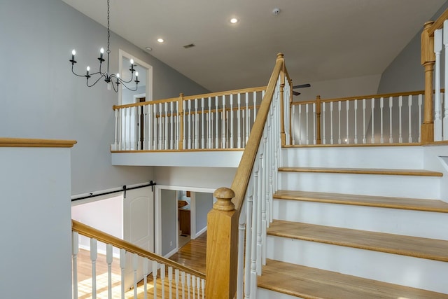 staircase featuring hardwood / wood-style flooring and a high ceiling