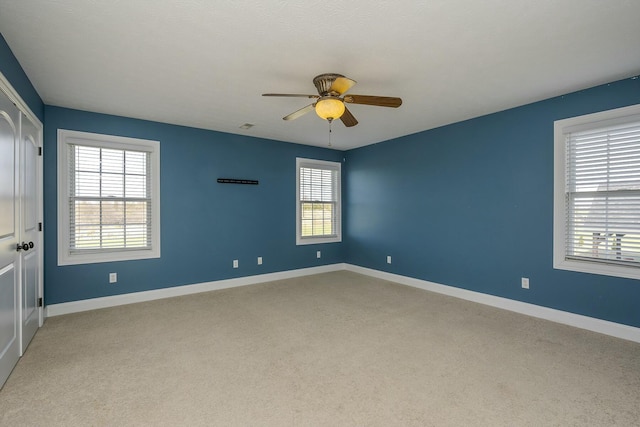 carpeted empty room with ceiling fan