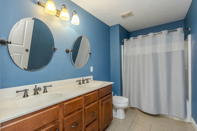 full bathroom with toilet, vanity, tile patterned floors, shower / tub combo, and a textured ceiling