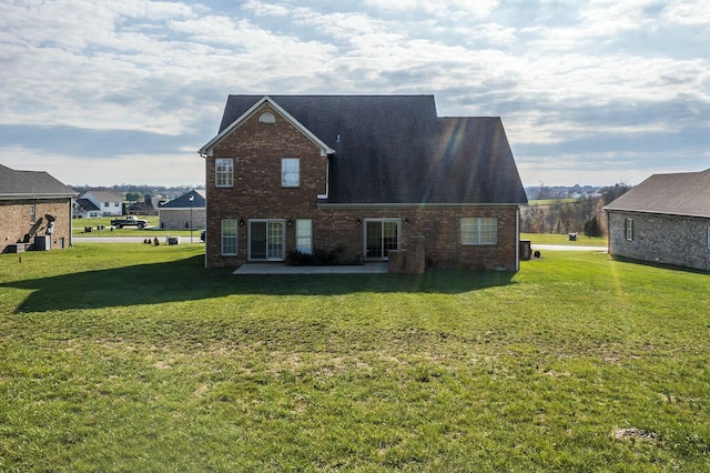 back of property featuring a patio area and a yard