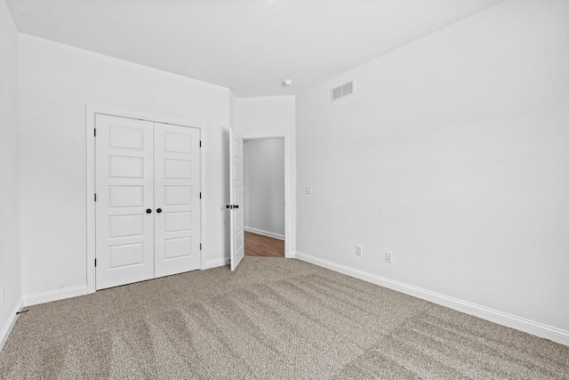 unfurnished bedroom with a closet and carpet