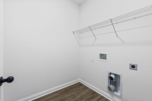 clothes washing area featuring dark wood-style floors, washer hookup, electric dryer hookup, laundry area, and baseboards