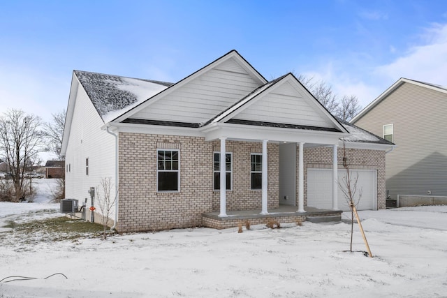 view of front facade featuring a garage and central AC