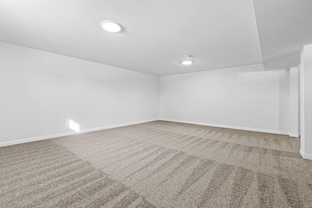 spare room featuring carpet flooring and baseboards