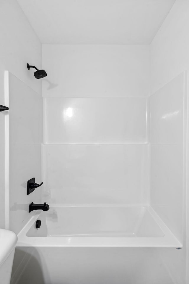 bathroom with shower / washtub combination and toilet