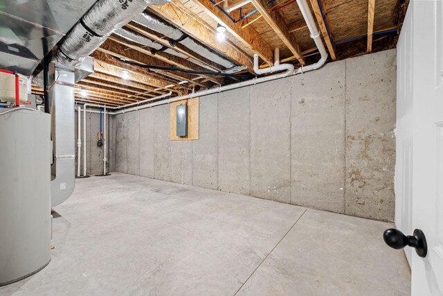 basement featuring heating unit and water heater