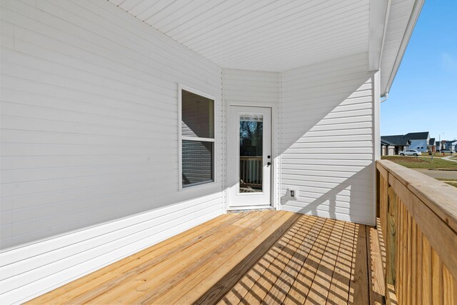 snow covered rear of property featuring a wooden deck