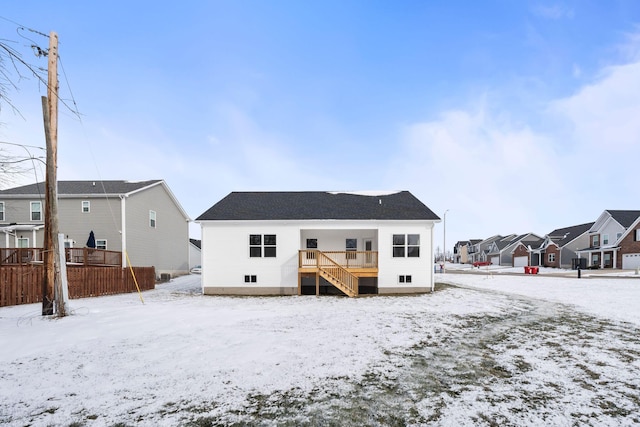 view of snow covered rear of property