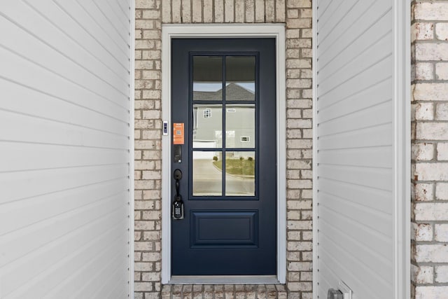 property entrance with brick siding