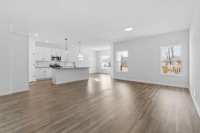 unfurnished living room featuring dark wood-type flooring