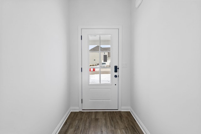 doorway to outside with dark wood-style floors and baseboards