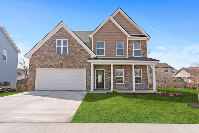 view of front of home with a porch, concrete driveway, a front lawn, a garage, and brick siding