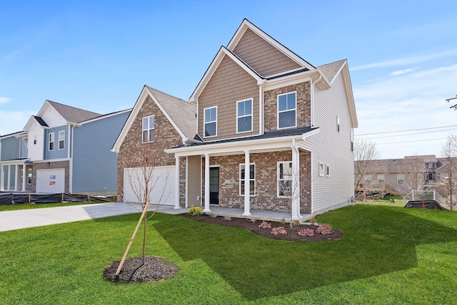 view of front of house with a garage, a front yard, a porch, and driveway