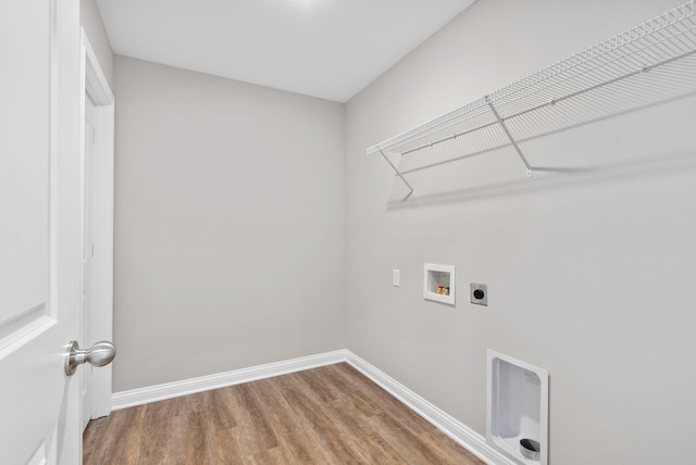 washroom with washer hookup, wood finished floors, baseboards, hookup for an electric dryer, and laundry area