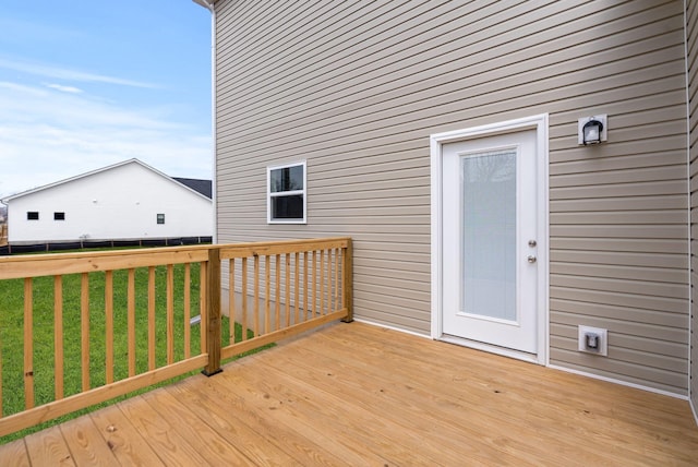 wooden deck with a yard and fence