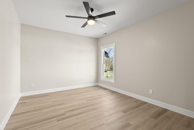 spare room featuring light hardwood / wood-style flooring and ceiling fan