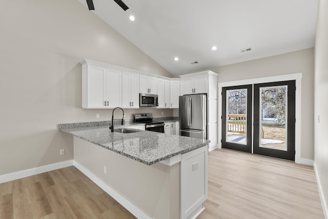 kitchen featuring white cabinetry, sink, light stone countertops, and appliances with stainless steel finishes