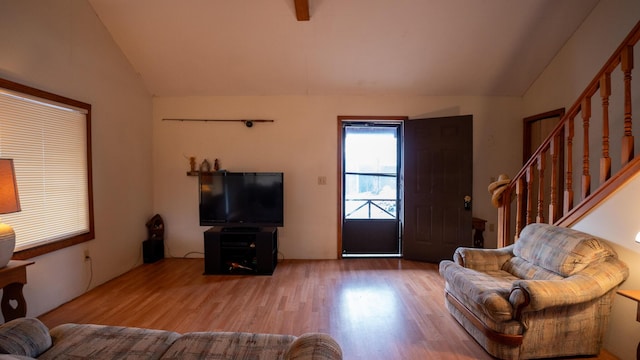 living room featuring wood-type flooring and lofted ceiling