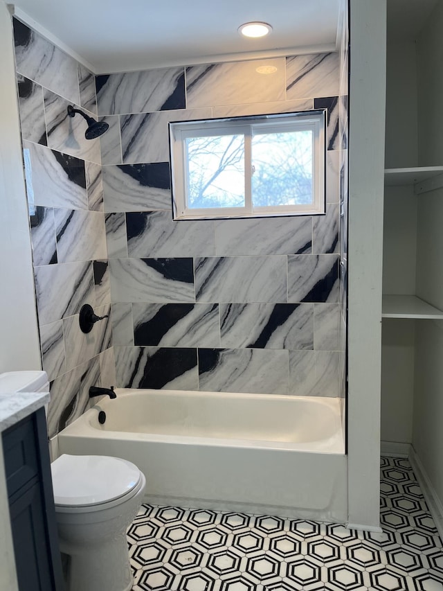 full bathroom featuring vanity, toilet, and tiled shower / bath combo