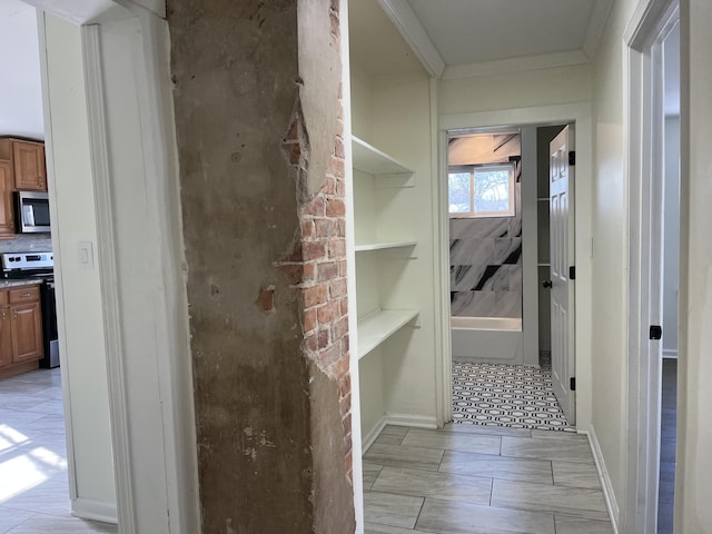 bathroom featuring crown molding and a tub to relax in