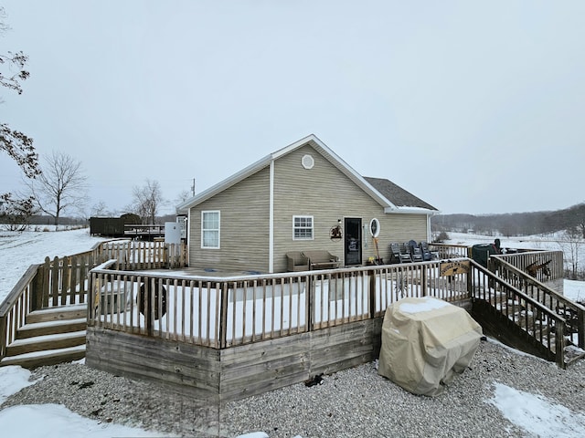 snow covered house with a deck