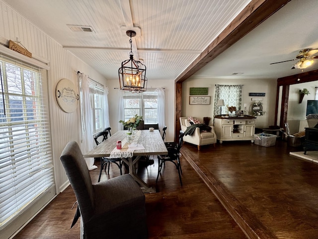 dining room featuring ceiling fan with notable chandelier, plenty of natural light, and dark hardwood / wood-style floors